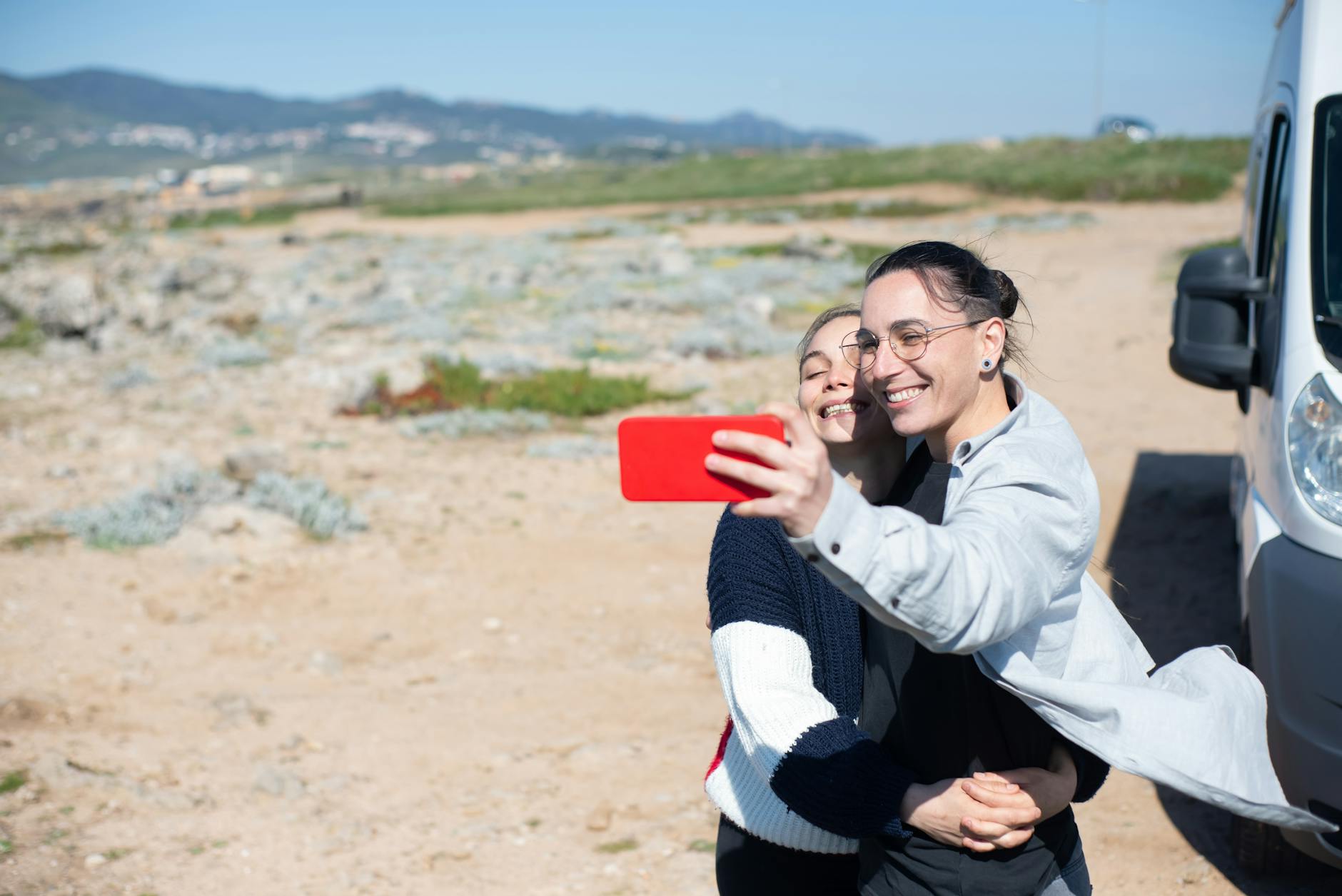 Happy couple taking a selfie with a scenic backdrop of Portugal. Perfect for travel and lifestyle themes.