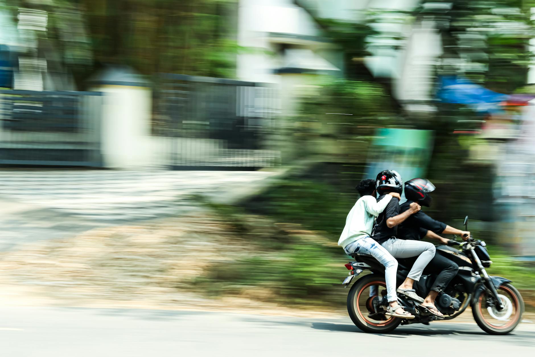 Blurred motion shot of two people riding a motorcycle on the streets of Kochi, India.