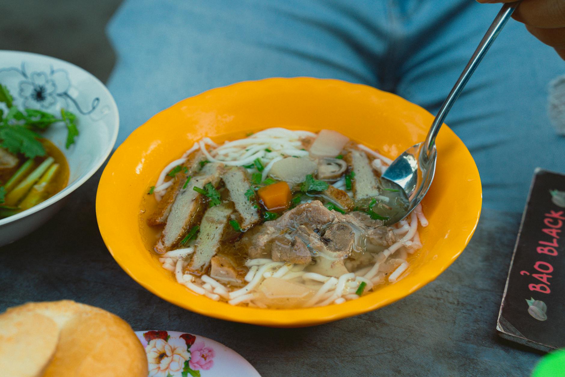 Close-up of traditional Vietnamese noodle soup served outdoors in Bình Thuận.