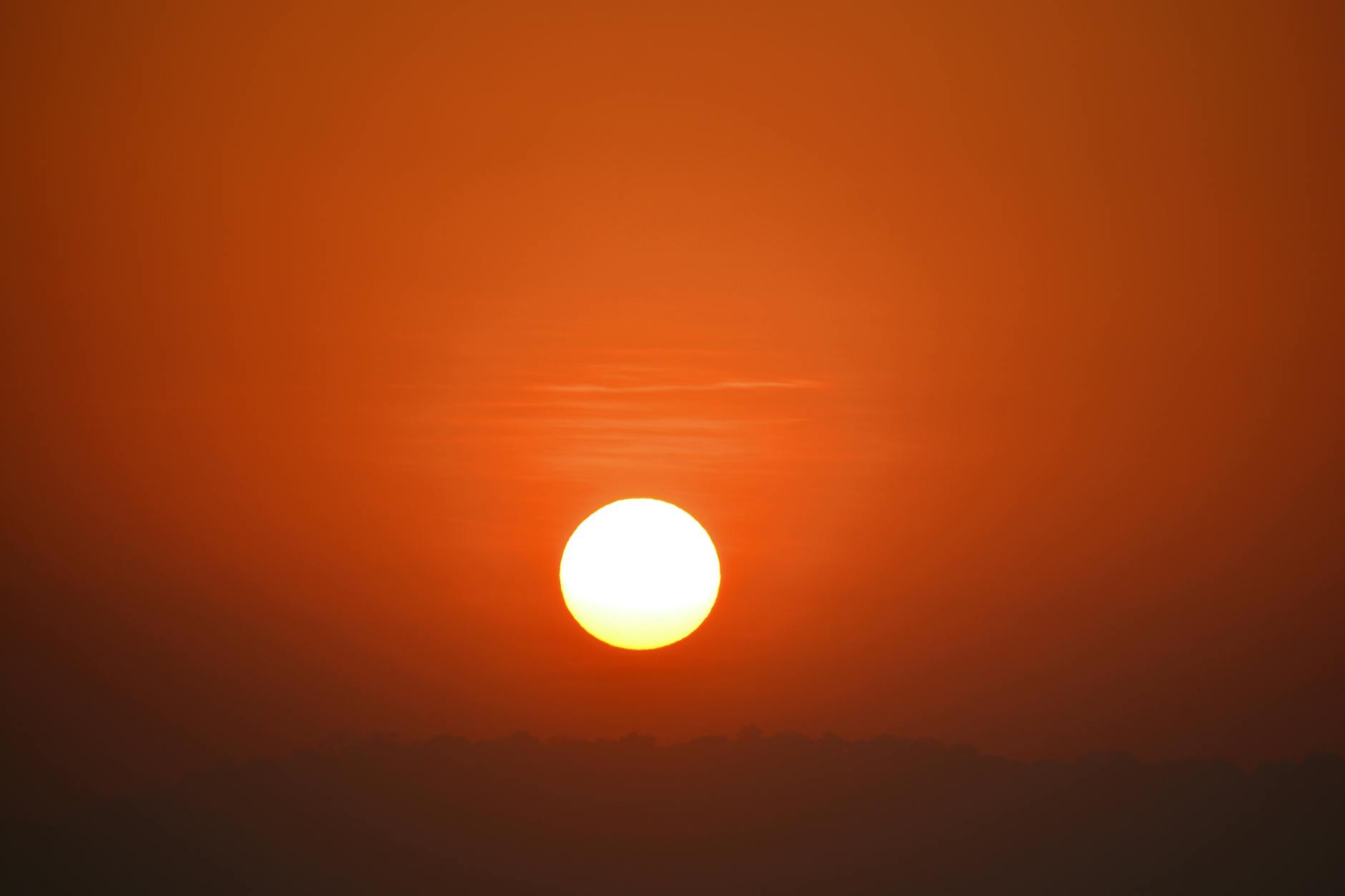 Captivating golden sunrise over Mumbai, with vivid orange and yellow hues filling the sky.