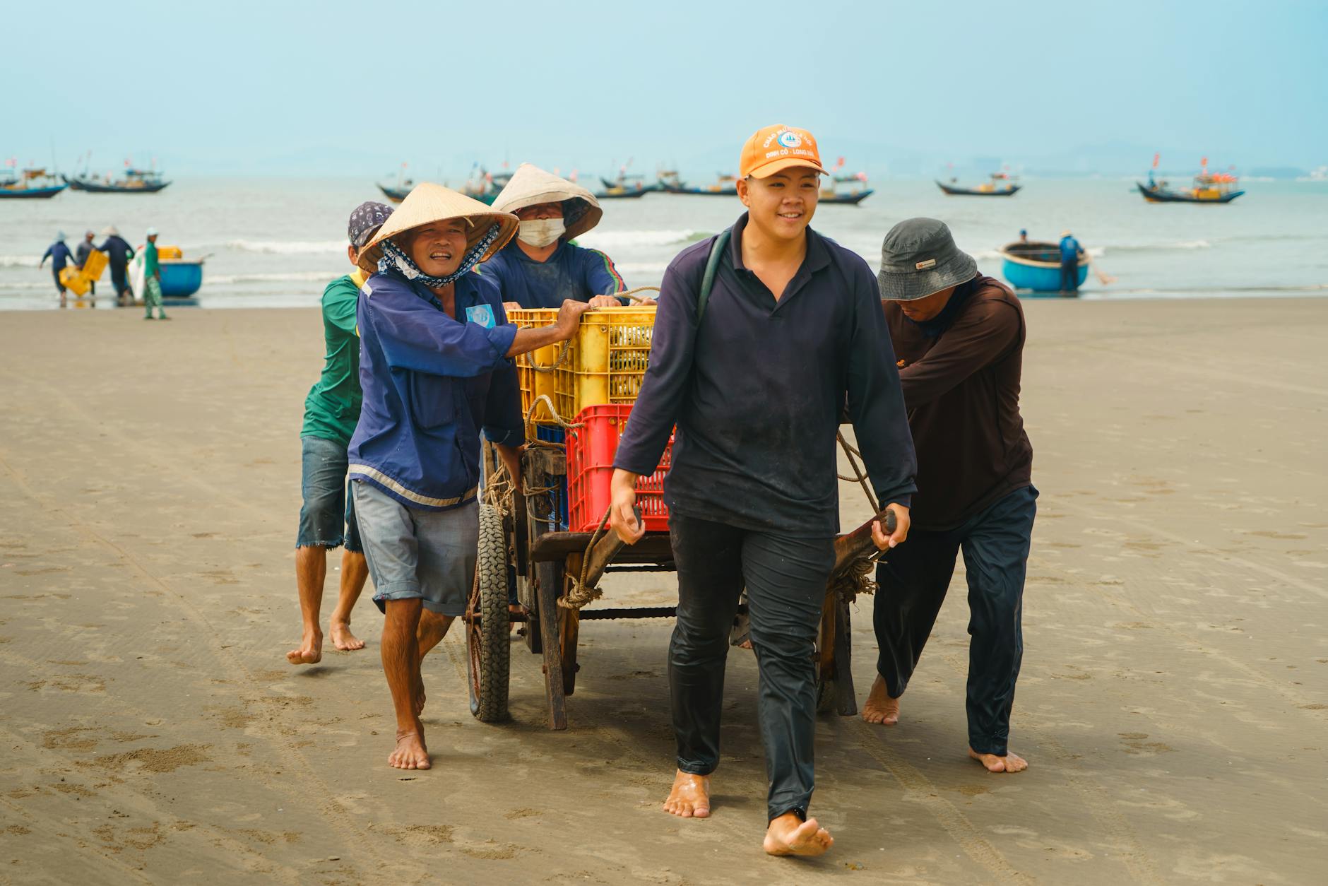 Fishermen in Vũng Tàu, Vietnam, engaged in traditional seafood harvesting by the coast.