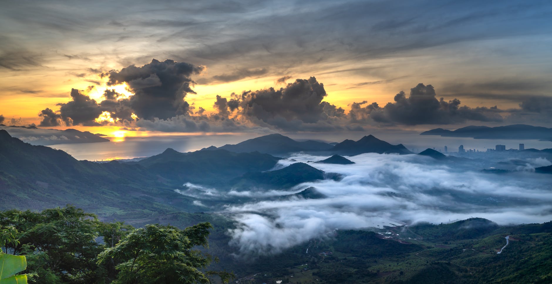 Breathtaking sunrise over fog-covered mountains and serene landscape.