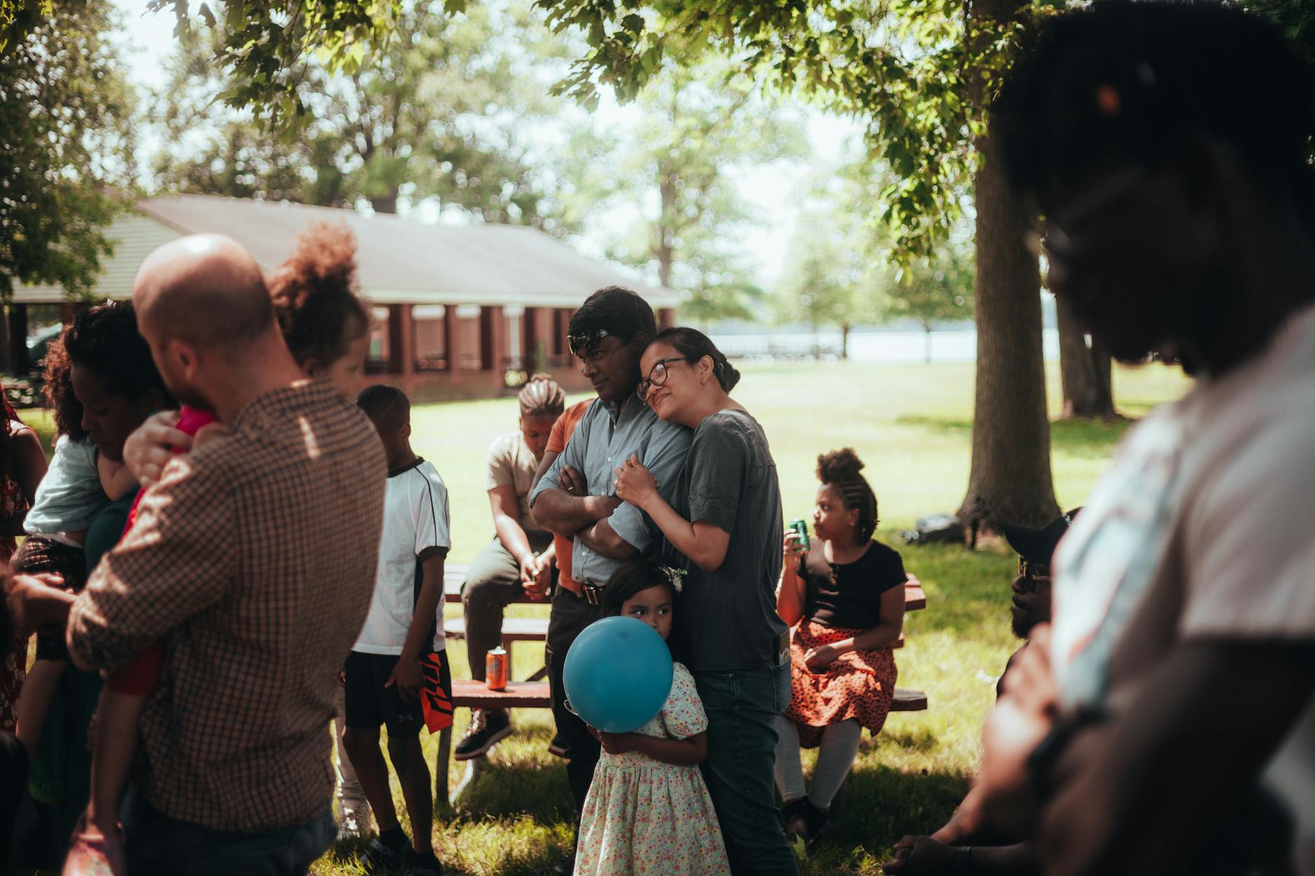 A diverse family enjoying a relaxing summer day in a park, capturing warmth and togetherness.