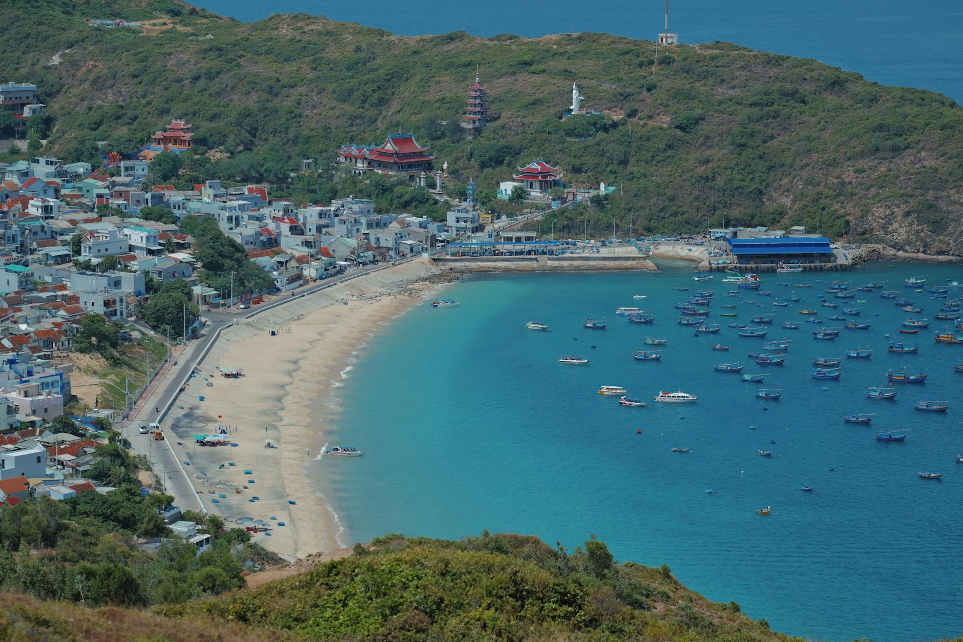 Aerial view of Quy Nhon beachfront with clear blue waters and sandy beach.