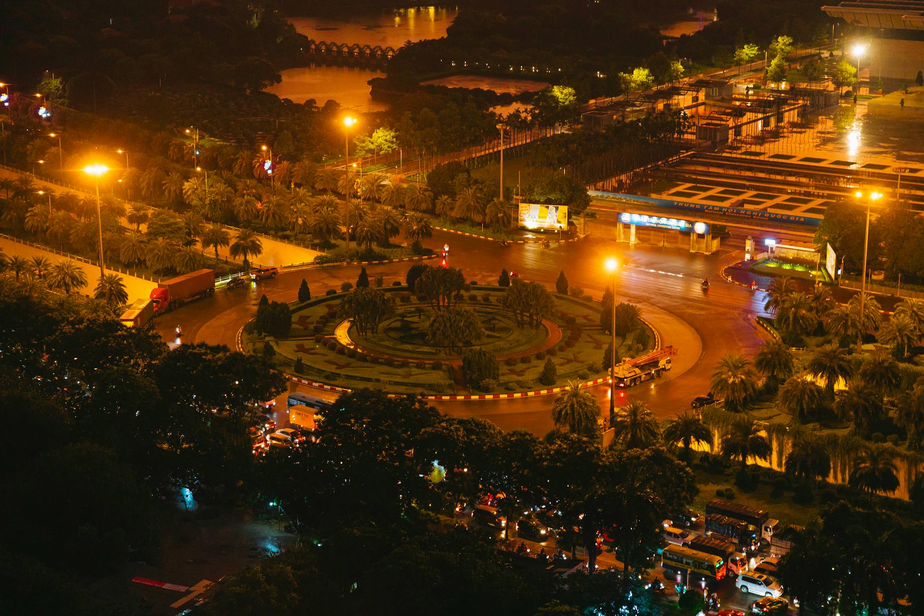 Aerial view of vibrant night traffic at Quy Nhon Square, Vietnam, showcasing illuminated streets and bustling activity.