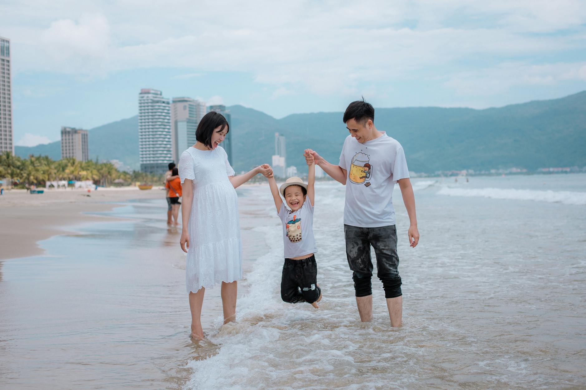 Family enjoying a day at Da Nang Beach, Vietnam, with a joyful child.