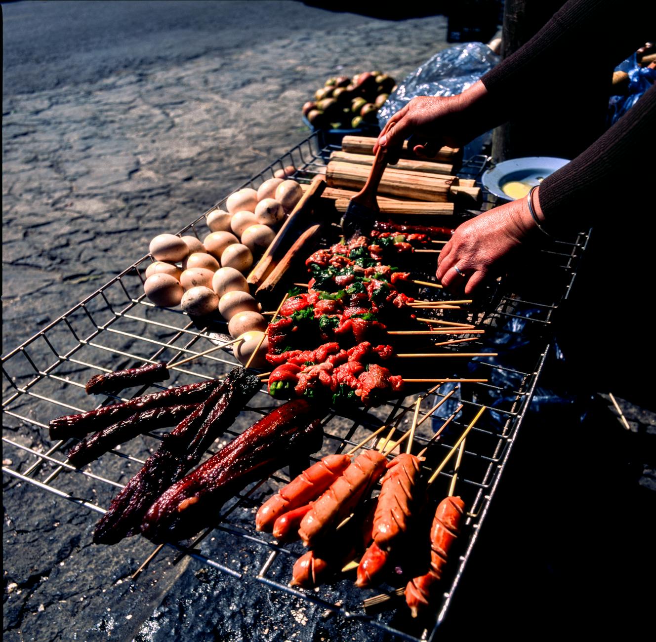 Delicious street food barbecue with skewers and eggs in Hà Giang, Vietnam outdoors.