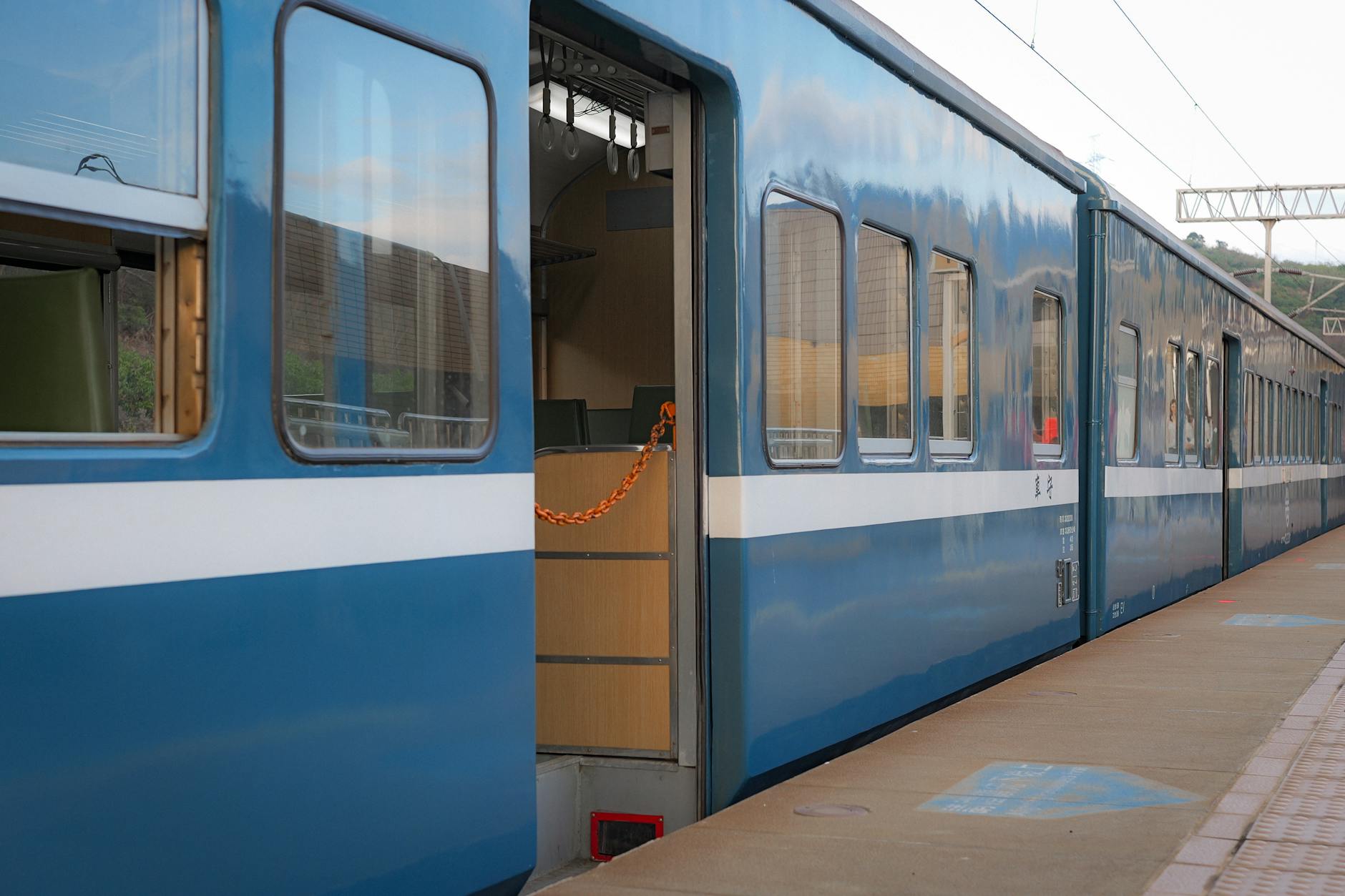 A scenic view of a blue train at a station in Taitung County, Taiwan. Perfect for travel and transportation themes.