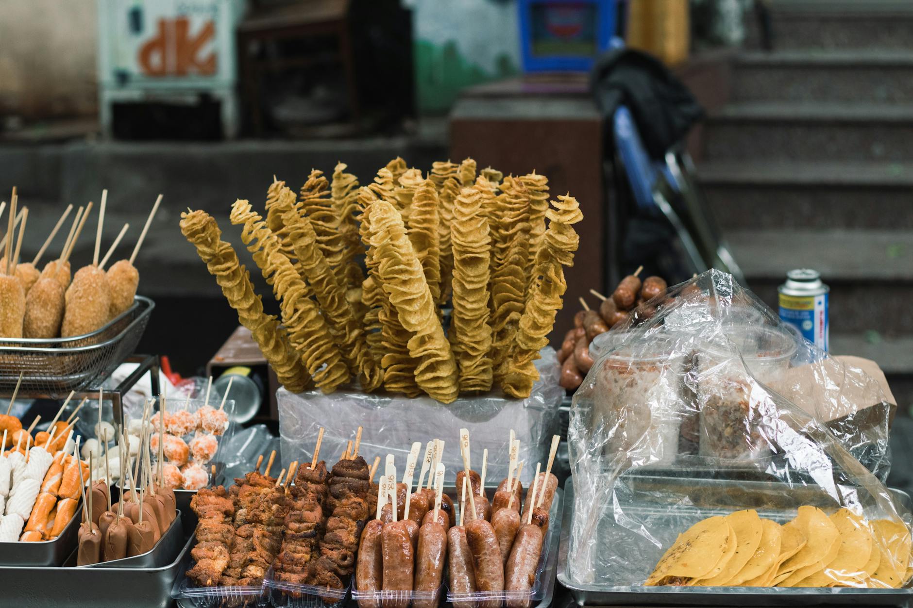 Assorted Vietnamese street food at an outdoor market stall in Hanoi.