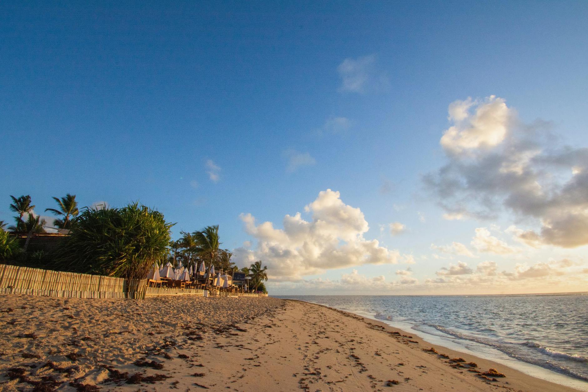 Stunning sunrise over a serene beach in Porto Seguro, Bahia, Brazil, showcasing golden sands and gentle waves.