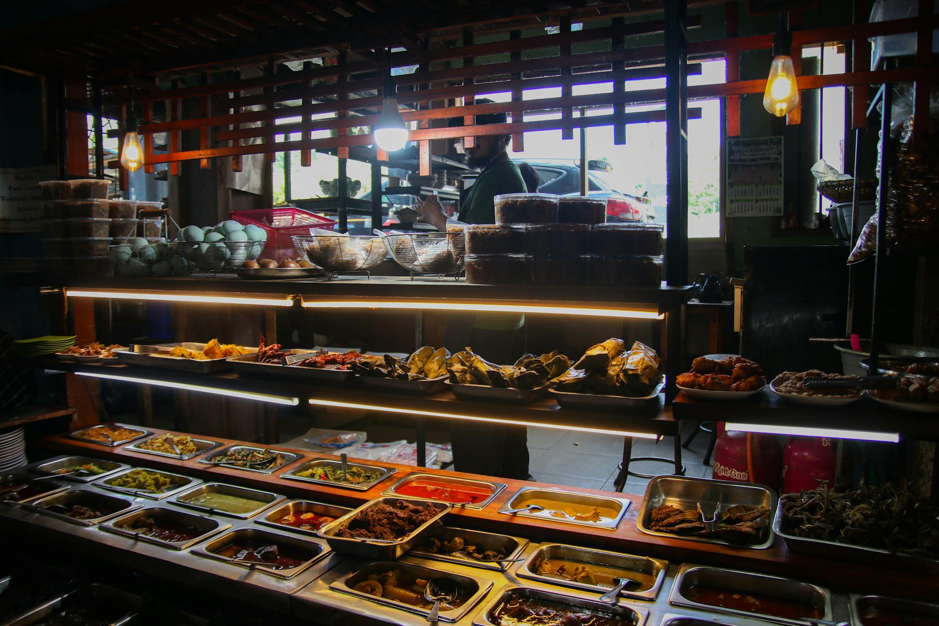 Explore the vibrant variety of Indonesian cuisine in a bustling West Java market buffet.