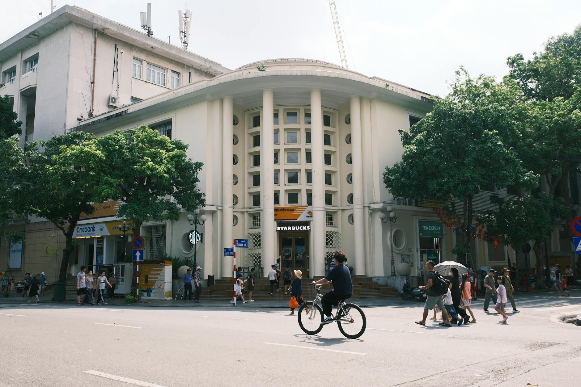 Vibrant street view in Hanoi, Vietnam capturing colonial architecture and everyday life.