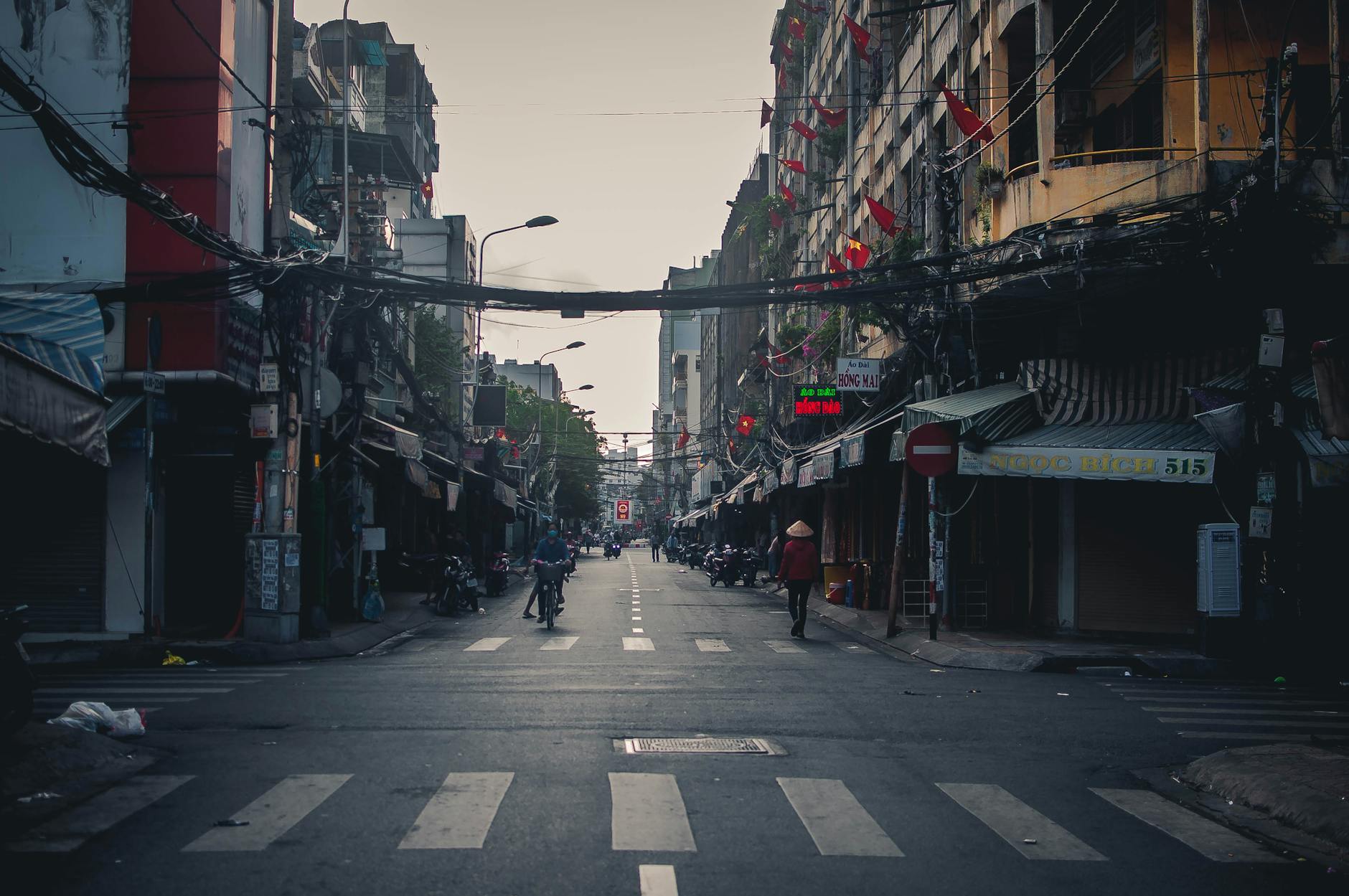 A quiet urban street scene in Ho Chi Minh City, Vietnam, showcasing local architecture.