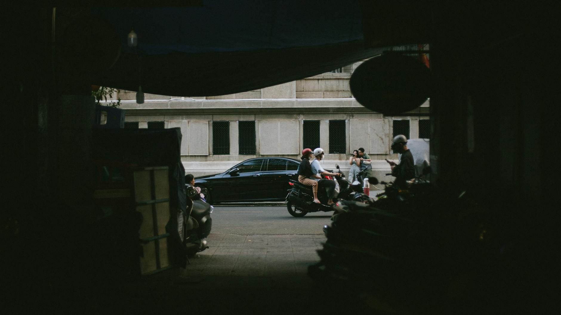 Street view of a bustling passage with motorcycles in Ho Chi Minh City, Vietnam.