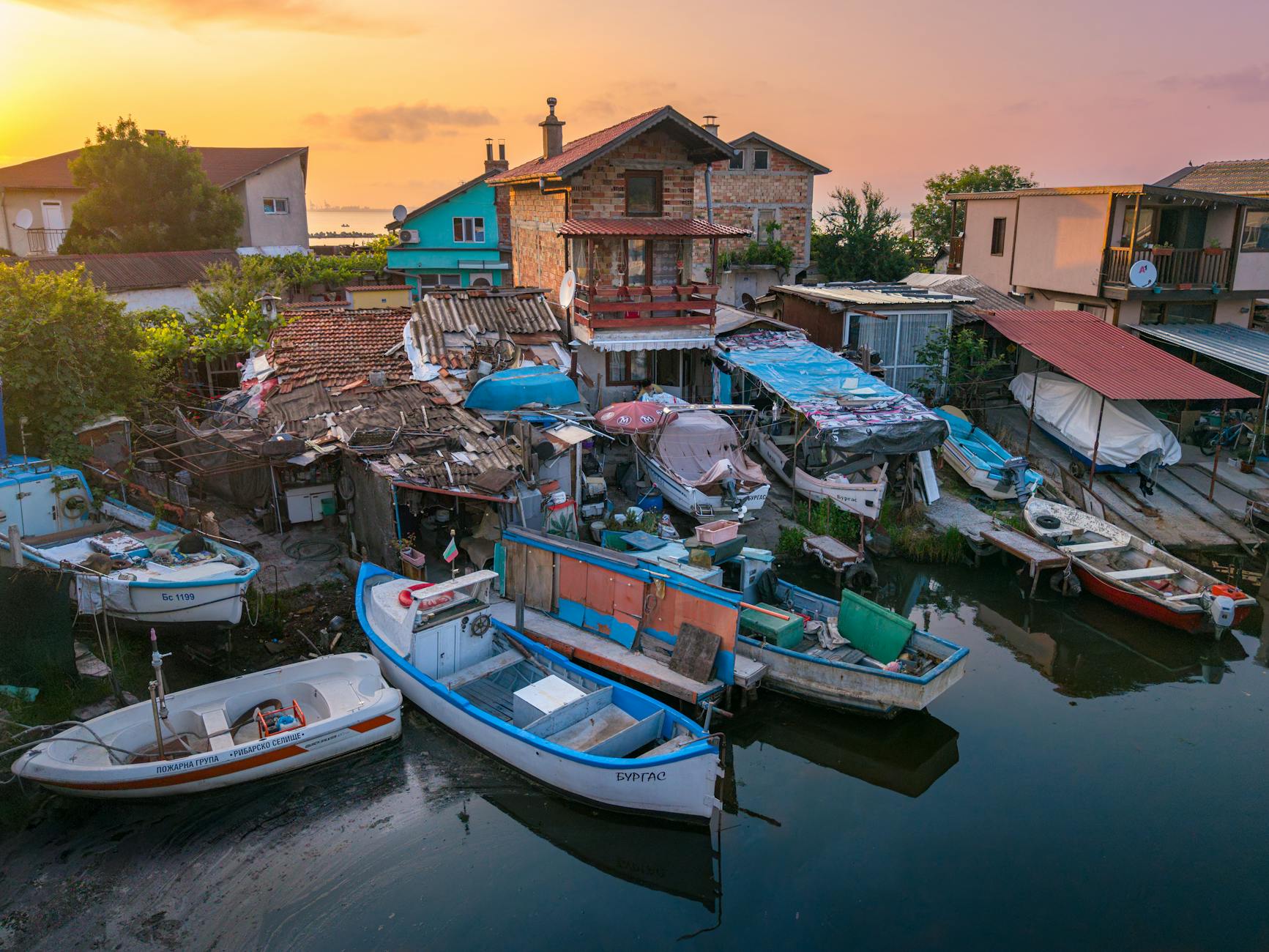 Explore the tranquil scene of colorful fishing boats at Burgas harbor, capturing the serene morning light.