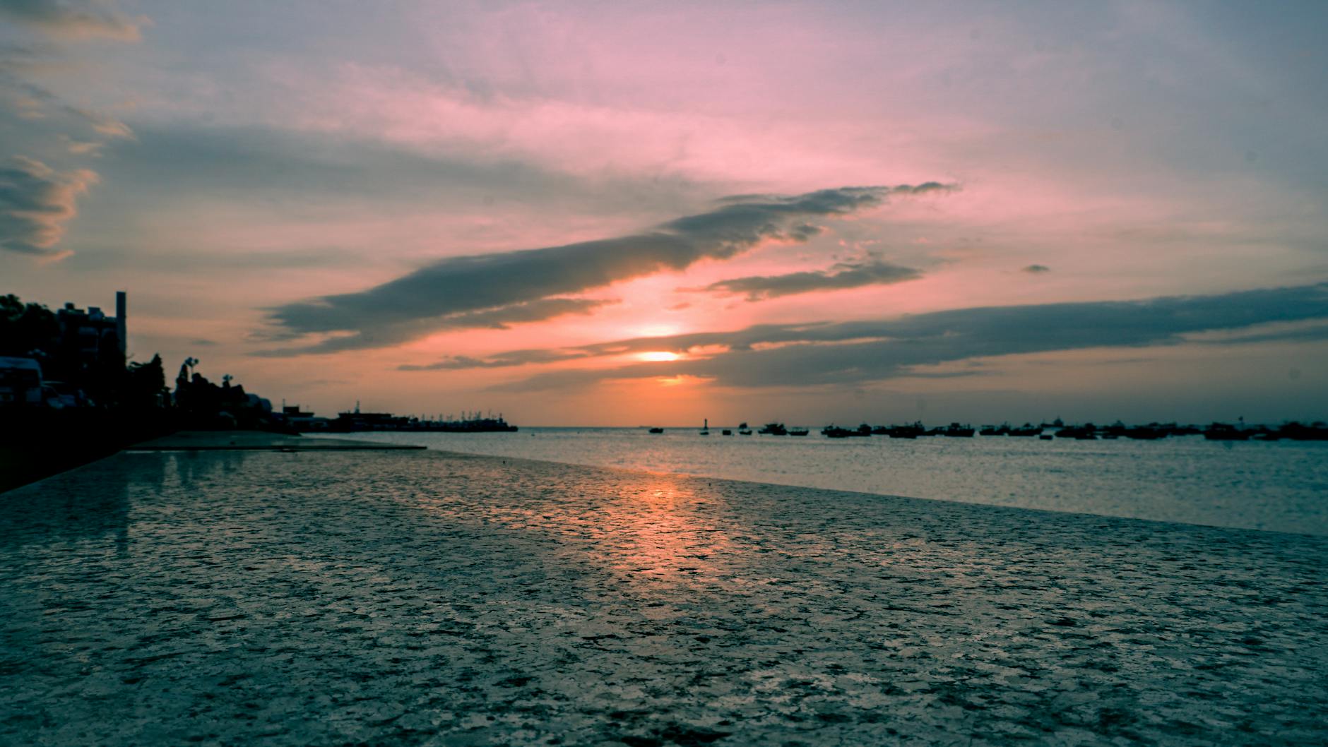 Experience a tranquil sunset over Vũng Tàu's coastline, reflecting a calming blend of hues.