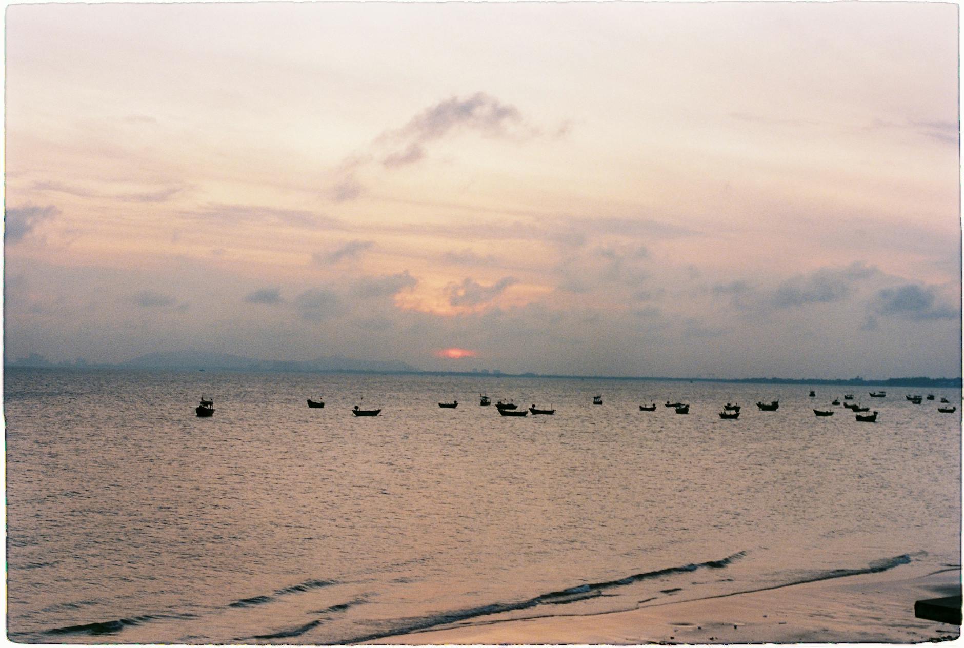 Tranquil seascape with boats at sunset in Vũng Tàu, Vietnam.