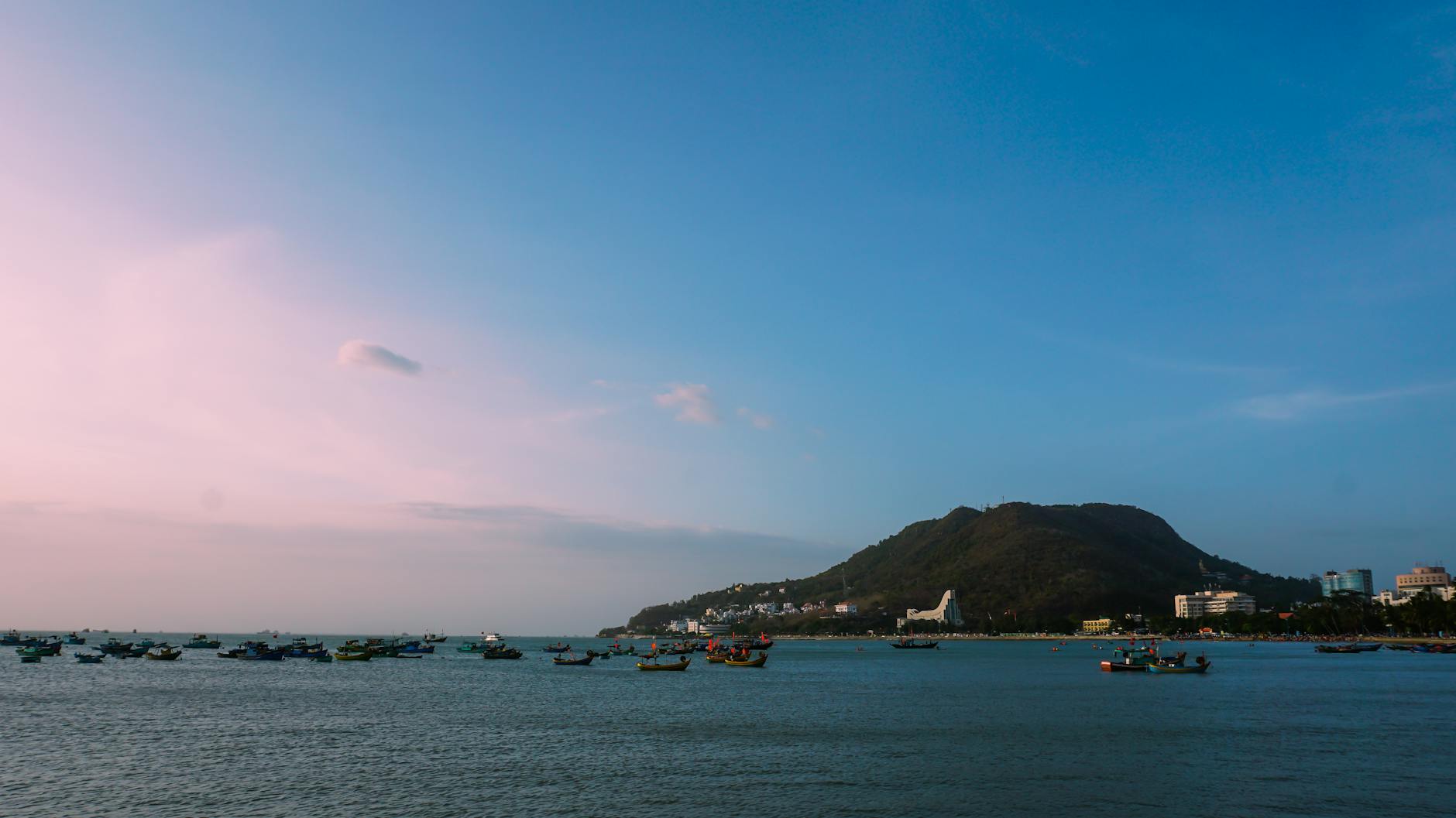 Beautiful seaside landscape with boats and mountains in Vũng Tàu, Vietnam.