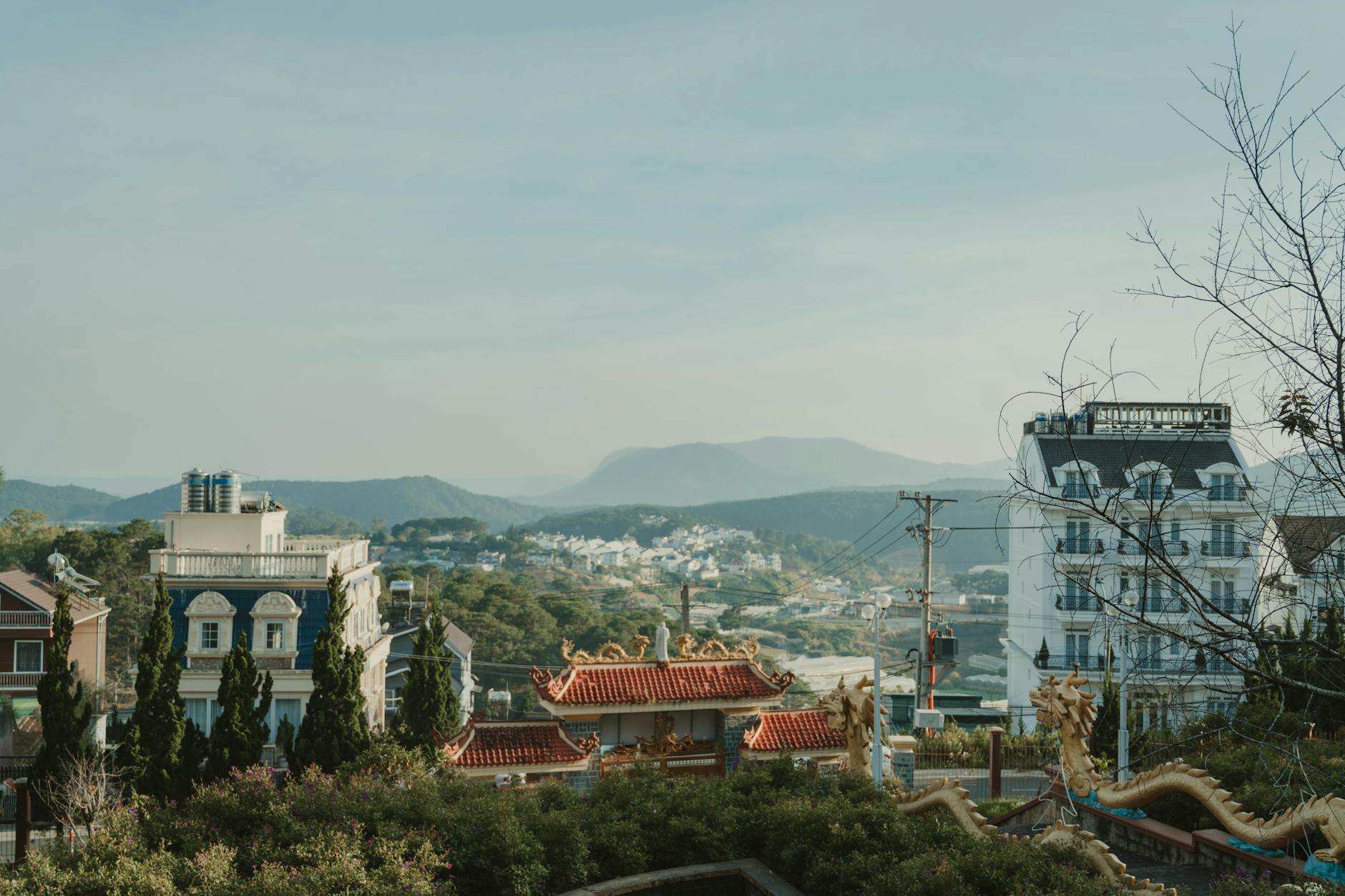 Explore the diverse architectural styles in Dalat with hills and vibrant buildings.