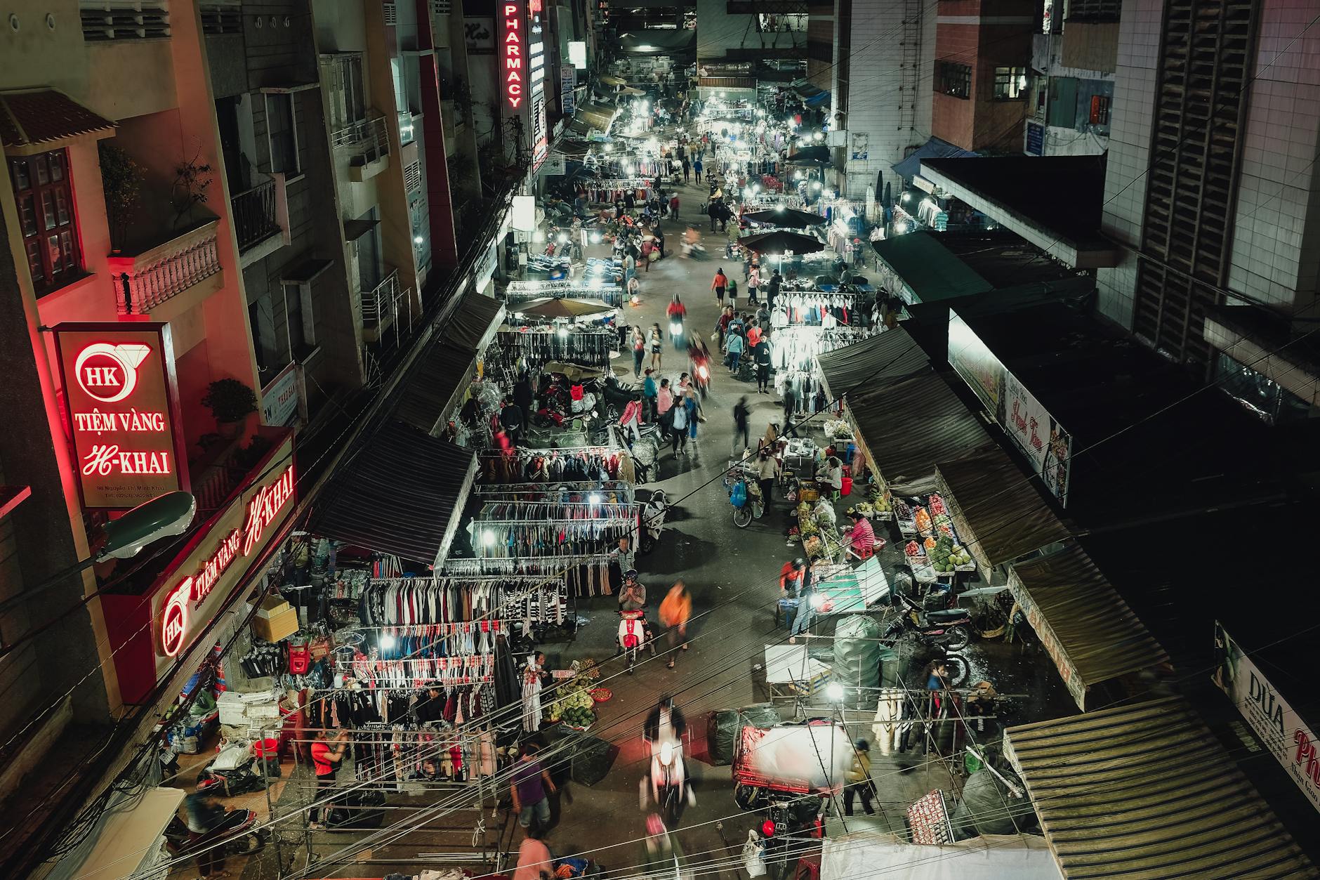 A vibrant aerial view of Dalat's night market with bustling stalls and street life.
