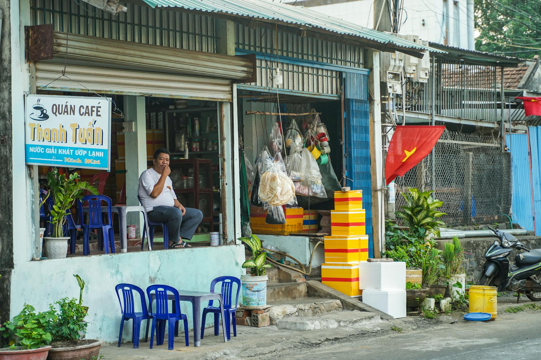 A quaint Vietnamese cafe with vibrant street scene and local character.