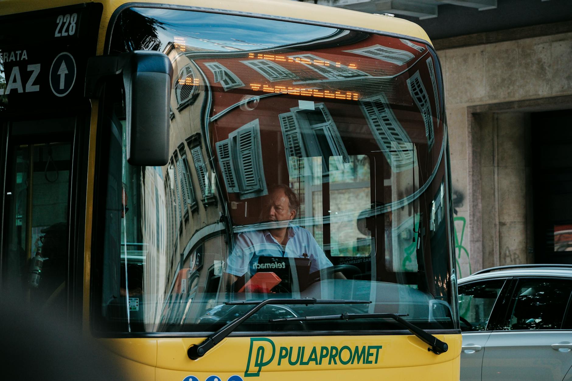 Candid shot inside a PULA bus featuring a male driver in Croatia.