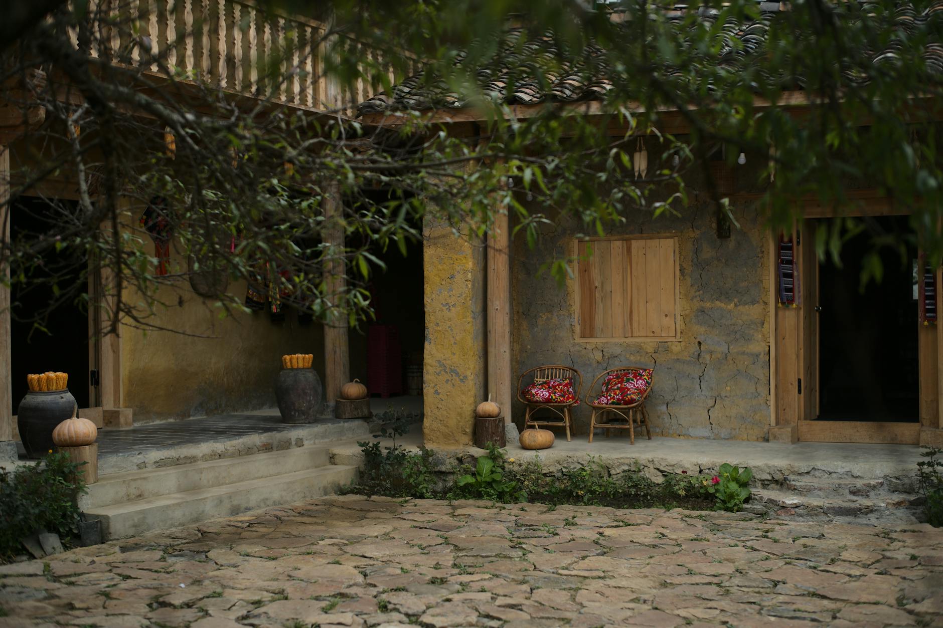 Explore the charm of a rustic Ha Giang courtyard featuring traditional architecture and serene atmosphere.