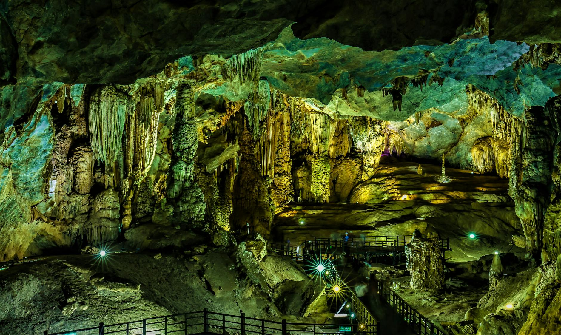 Breathtaking view of intricately illuminated stalagmites and stalactites in a Quảng Bình cave.