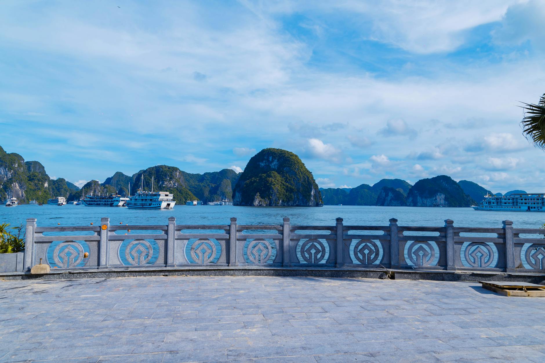 Blue skies over Ha Long Bay with cruise boats and limestone islands in Vietnam.