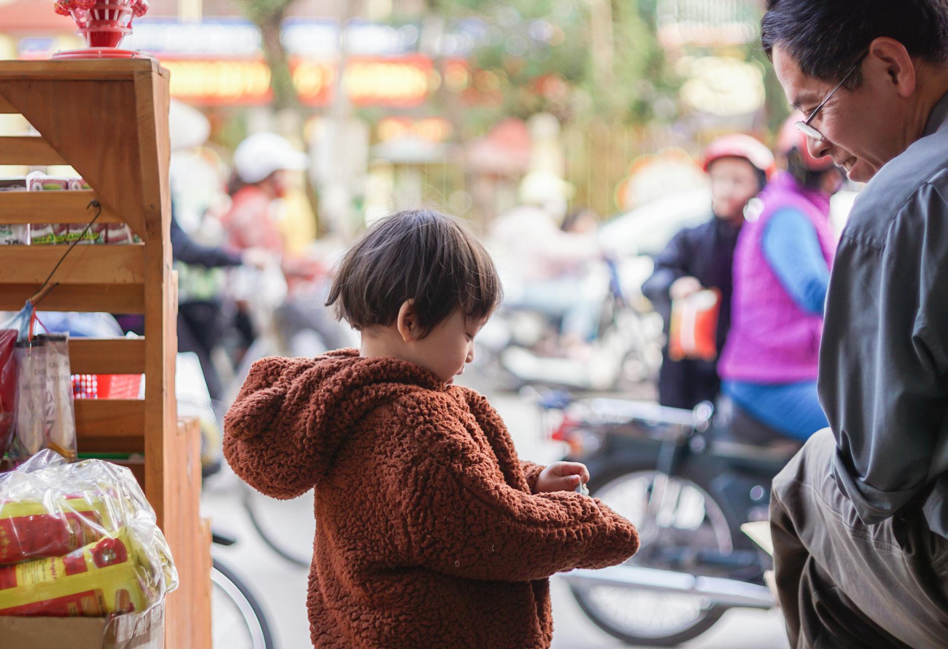 A father and child enjoy a shopping trip outdoors in Hà Giang, Vietnam.