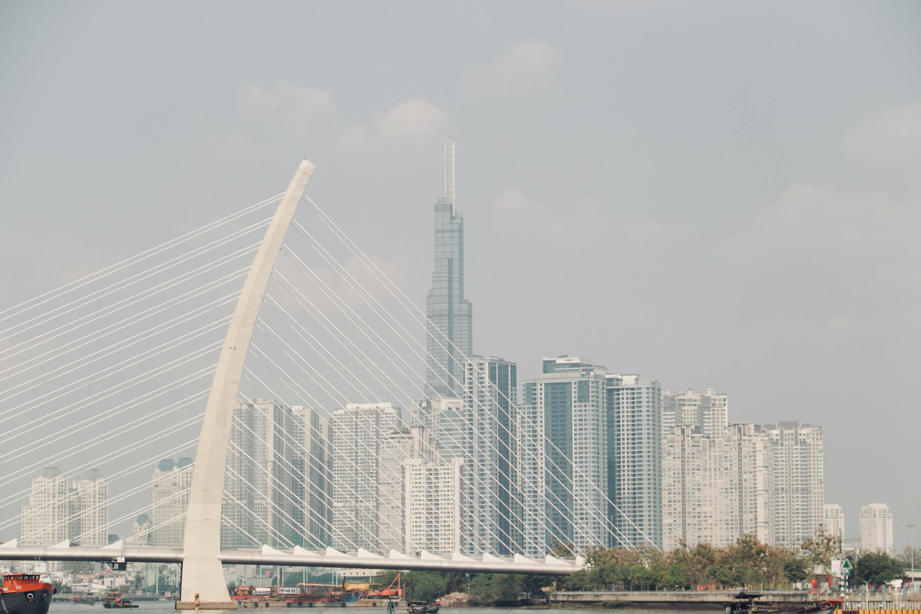 Skyline of Ho Chi Minh City featuring Thu Thiem 2 Bridge and modern skyscrapers on a clear day.