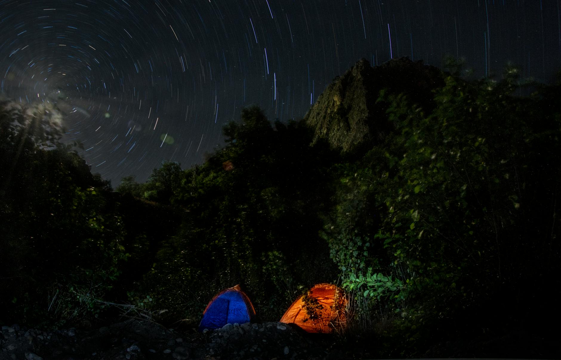 Experience star trails above tents in the serene Malatya wilderness. Perfect outdoor adventure scene.