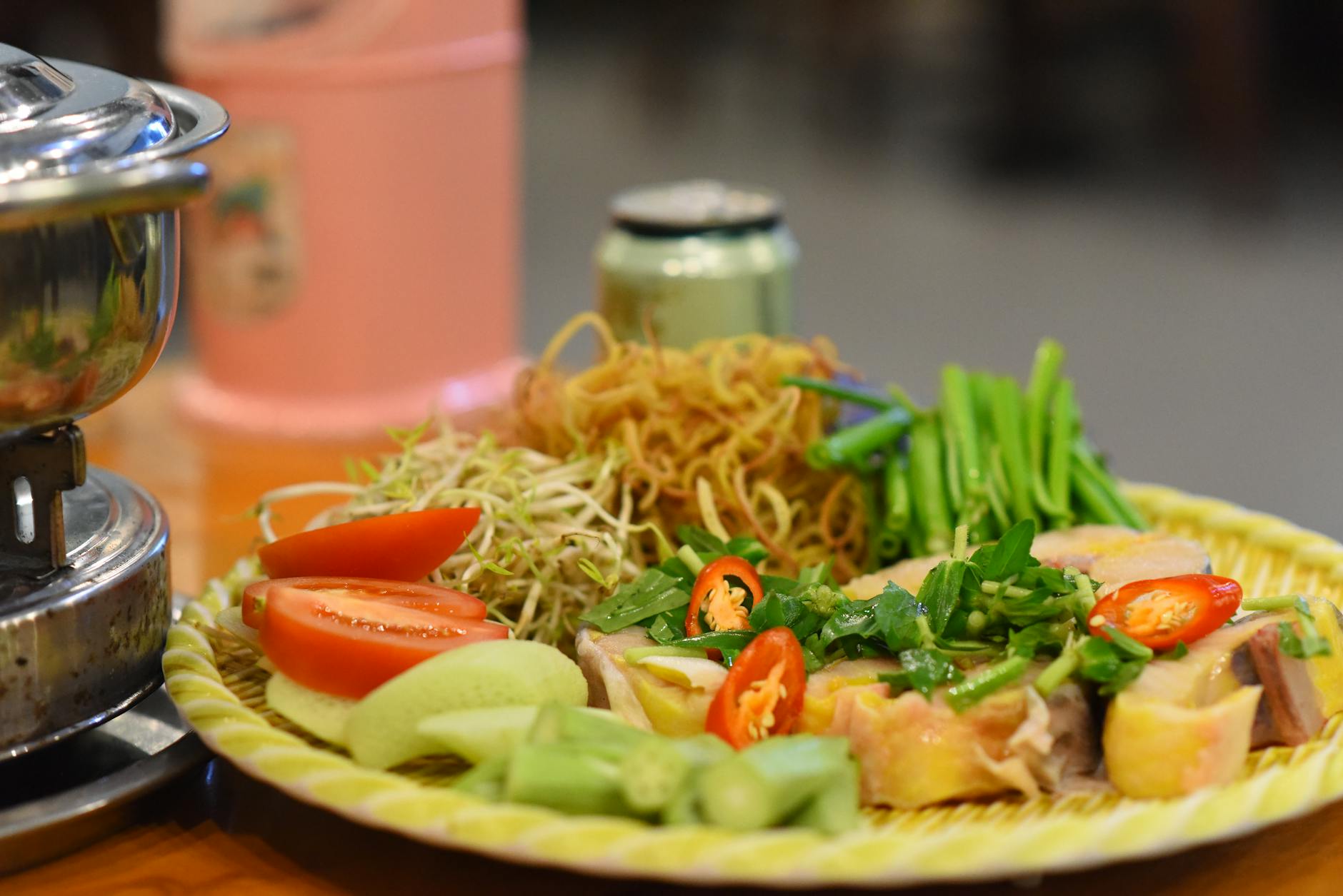 Colorful Vietnamese meal featuring noodles, vegetables, and herbs, perfect for authentic culinary themes.