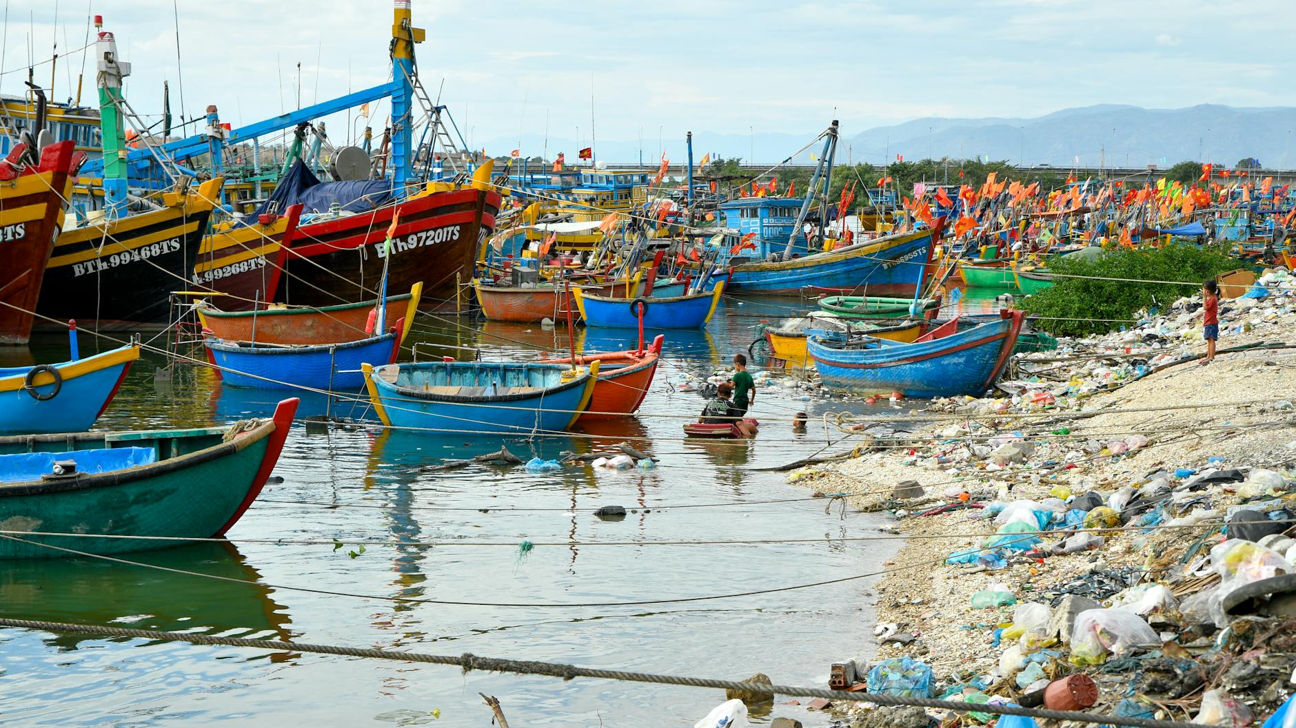 Vibrant view of local fishing boats at Phan Thiet harbor in Vietnam, showcasing traditional maritime culture.