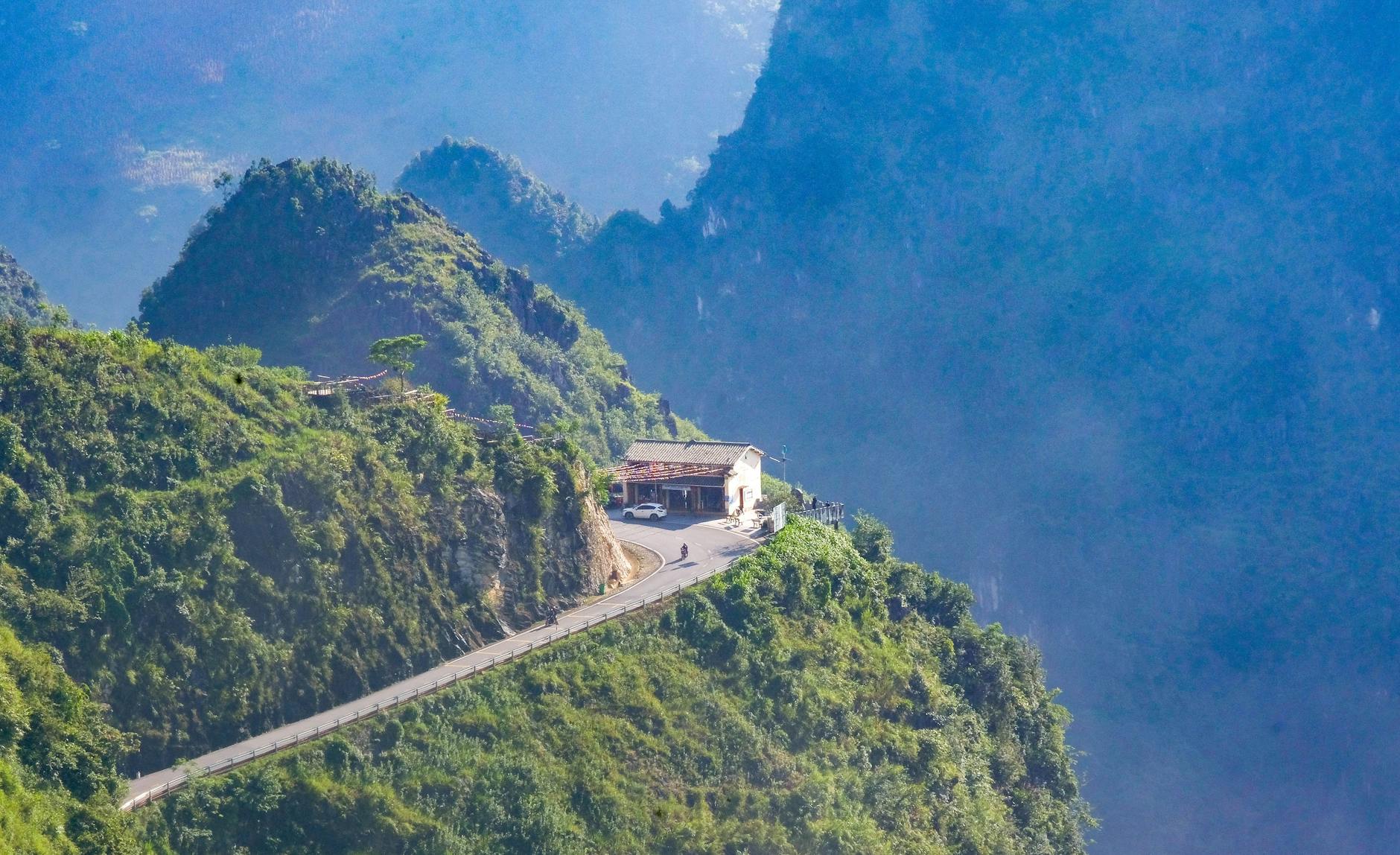 Stunning mountainous landscape in Hà Giang, Vietnam, showcasing lush green hills and a winding road.