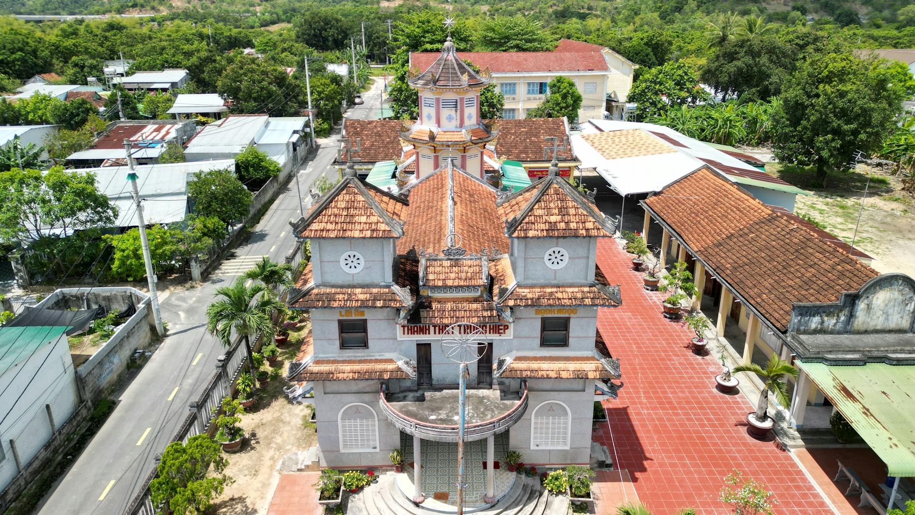 Aerial photo capturing the historic architecture and vibrant rooftops of a building in Nha Trang, Vietnam.