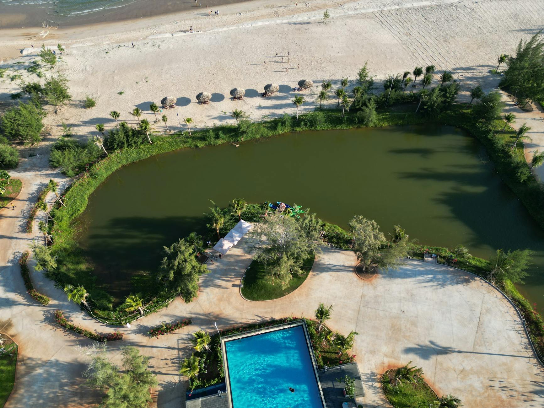 Stunning aerial shot of Hồ Tràm beach, lagoon, and resort pool in Vietnam.