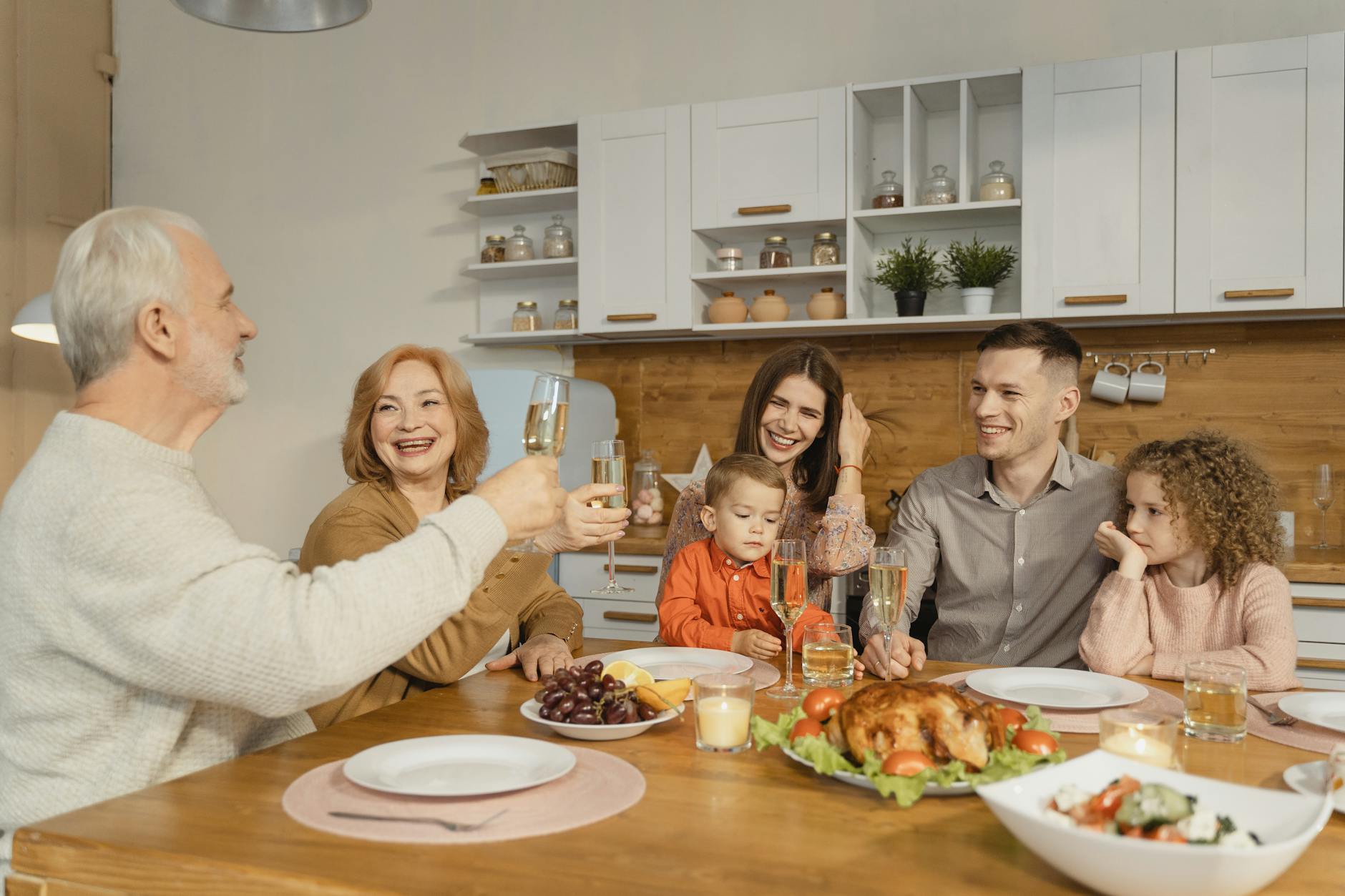 A joyful family gathering at home, celebrating Thanksgiving with food and smiles.
