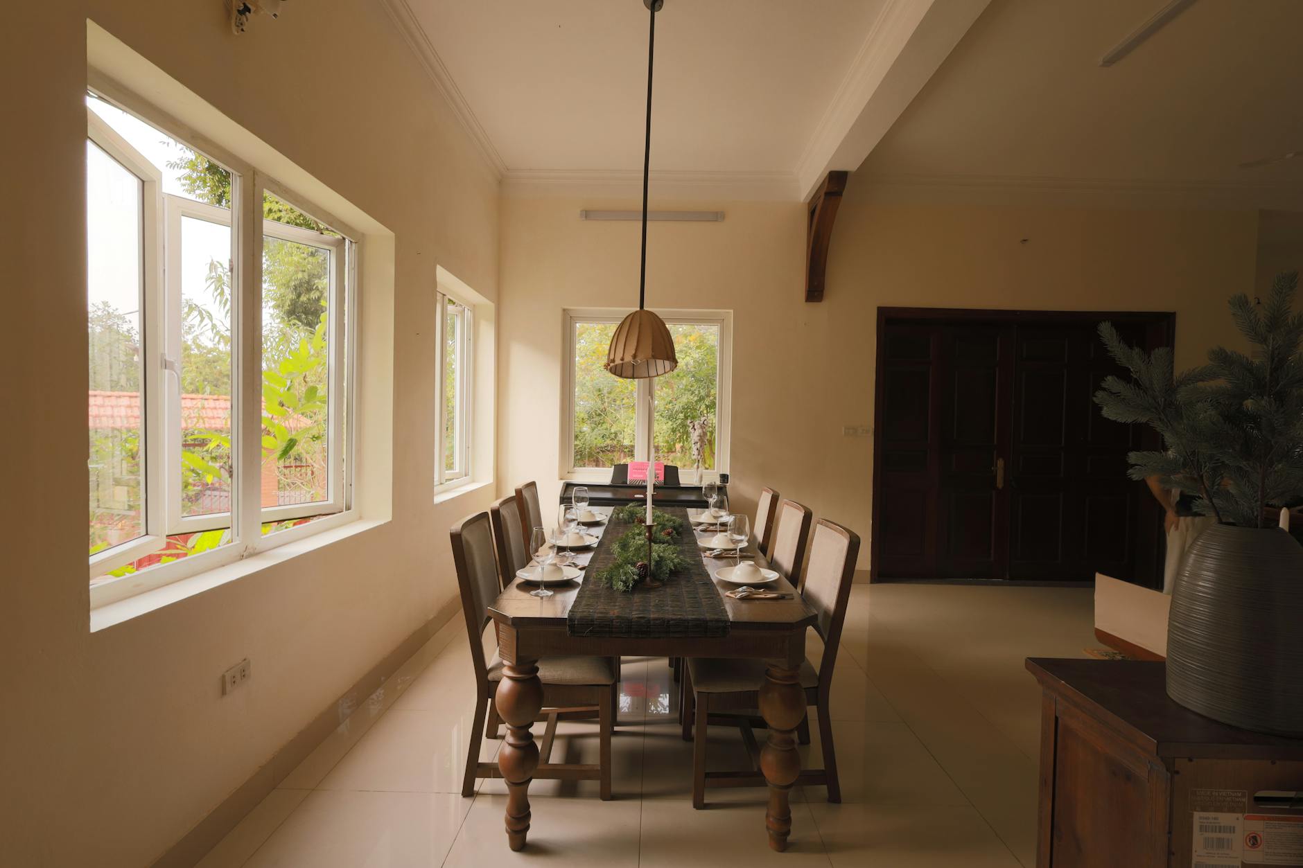 A warm dining area in Vietnam with a festive table setting, ready for a holiday gathering.