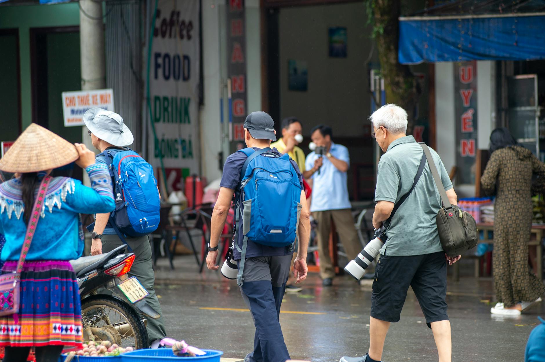 Photographers capturing vibrant scenes at Bắc Hà market, showcasing local culture in Lào Cai, Vietnam.