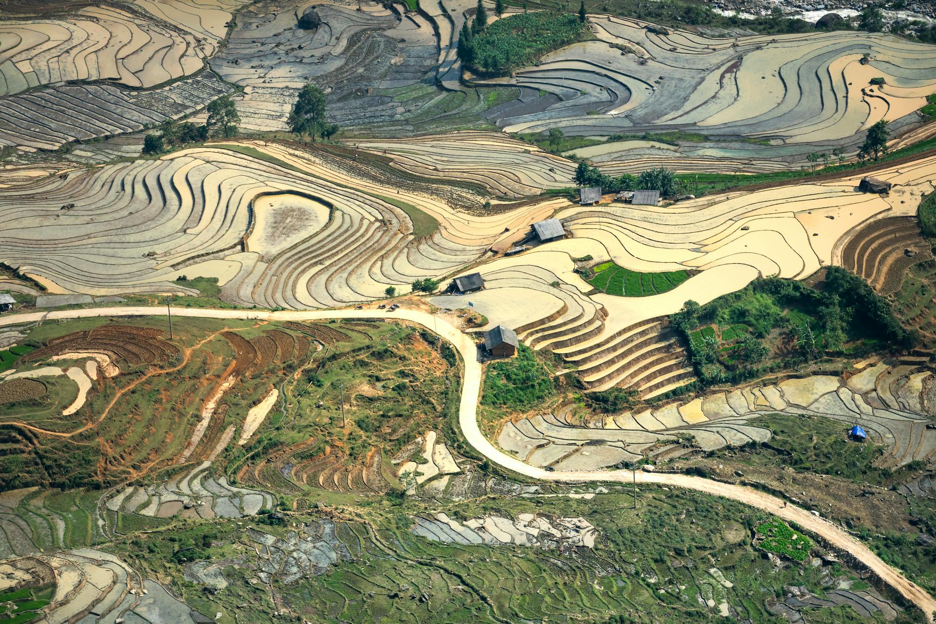 Explore the mesmerizing rice terraces of Mu Cang Chai captured in an aerial view showcasing the region's agricultural landscape.