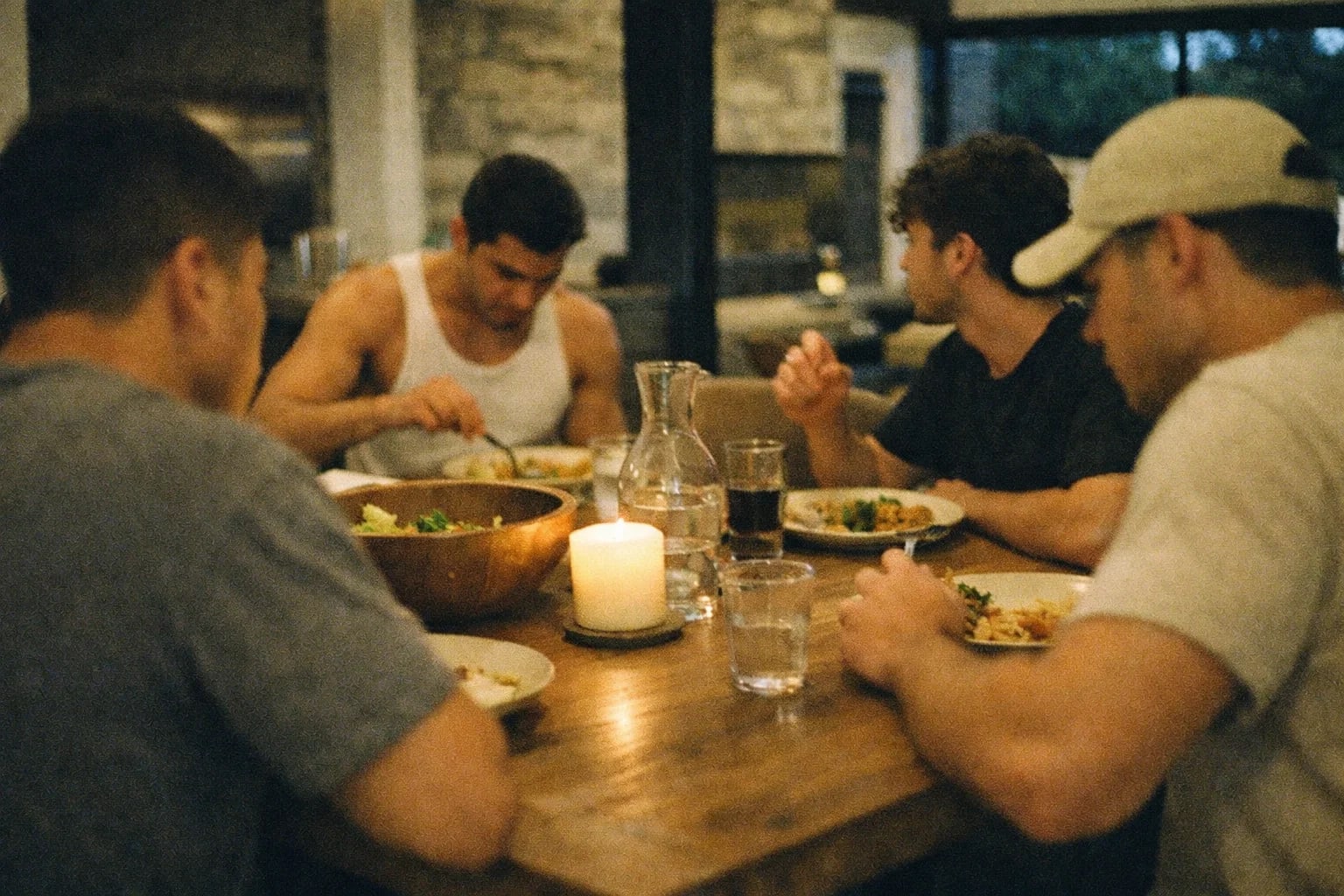 Men at The Den eating together at the table