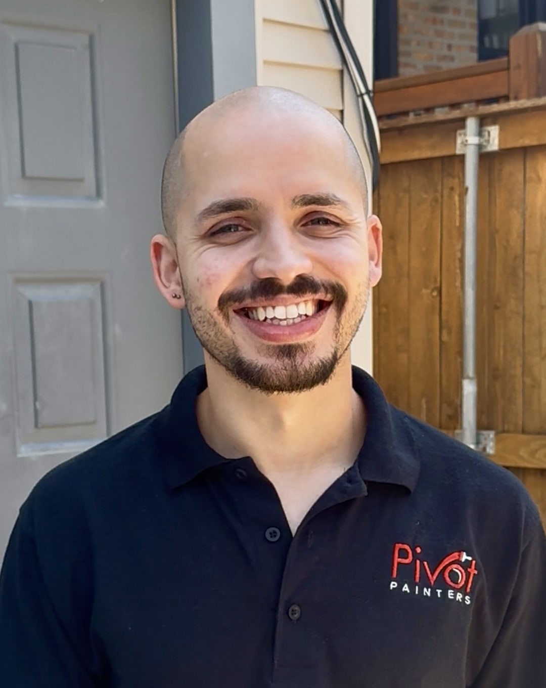Manny Munoz, owner of Pivot Painters, in company uniform