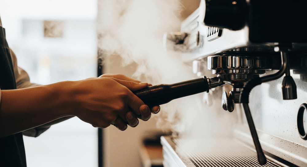Steam rising from an espresso machine group head