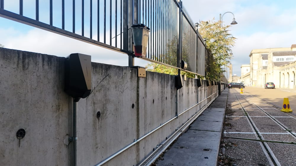 View along the charger run and steel conduit with the listed waterhouse building and car park at Hampton.