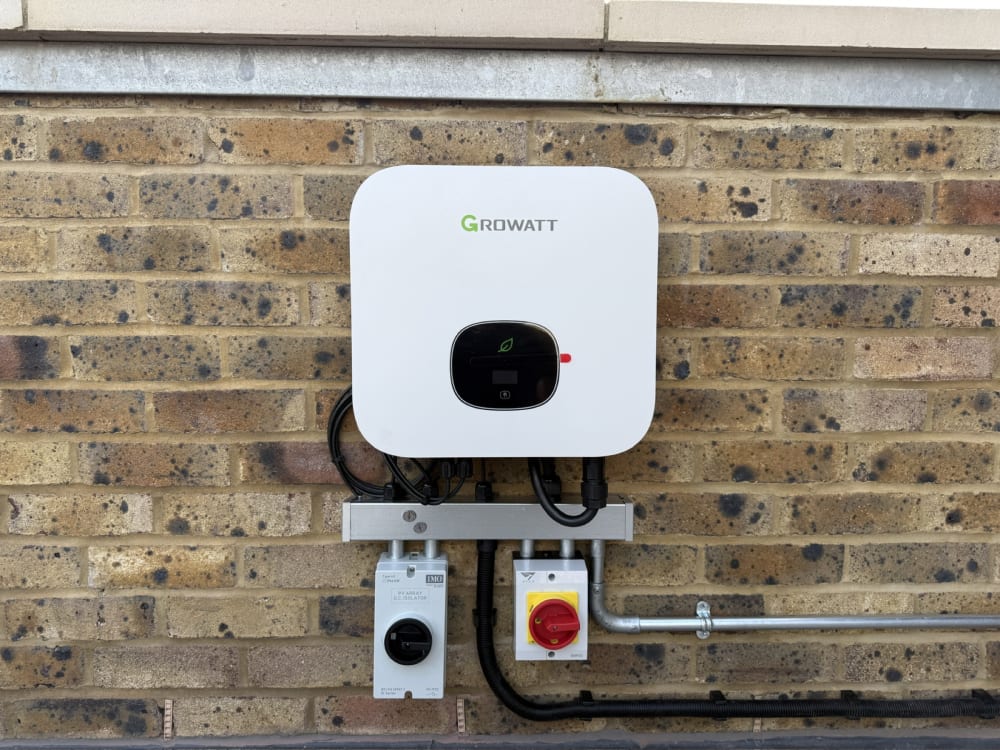 Close-up of the Growatt MIN 2500 TL-XH hybrid inverter with IMO AC and DC isolators at Fort Mount show home, Margate, Kent.
