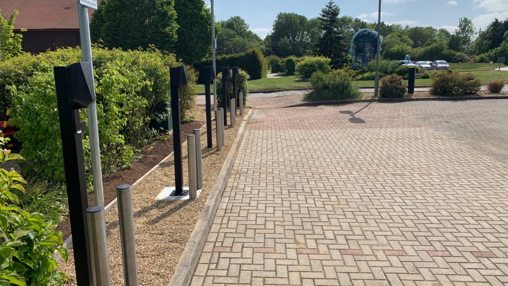 Completed Easee EV charger pedestals in landscaped parking area at The Hospice of St Francis, Berkhamsted.