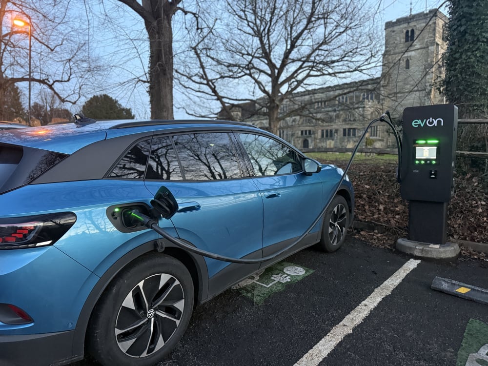 Blue electric vehicle charging on an EV-ON public rapid charger at Jockey Lane Car Park in Cranbrook, Kent.