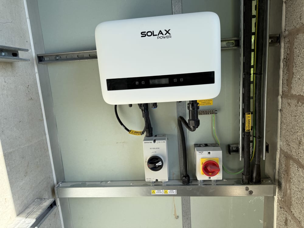 SolaX X1-BOOST G4 inverter with DC and AC isolators in the Level 12 lift lobby, Old Kent Road, Southwark.