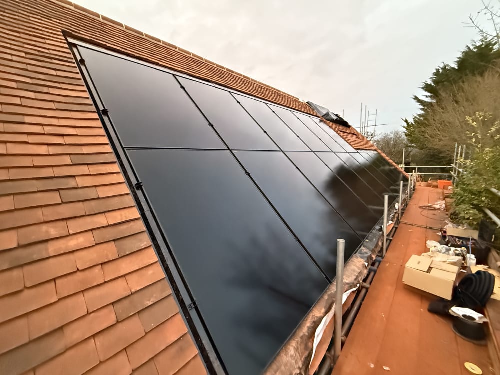 Completed in-roof solar installation on Pages Cottage, a detached cottage in Broxted, Essex, with all-black Aiko panels flush within the clay tile roof.